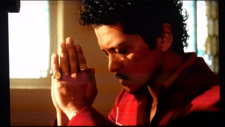 Bruno Mars prays in a prerecorded video shown at the opening of his The Romantic Tour concert at Vancouver’s BC Place.(YouTube)